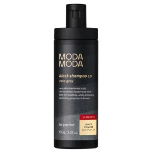 Czarna butelka szamponu przeciw siwieniu włosów z serii MODA MODA, opracowanego z kompleksem Black Change Complex EX, który stopniowo przywraca włosom ciemniejszy odcień.