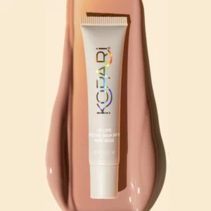 Kopari Lip Love Moisture Balm Nude Beige balsam do ust na tle rozprowadzonej formuły.