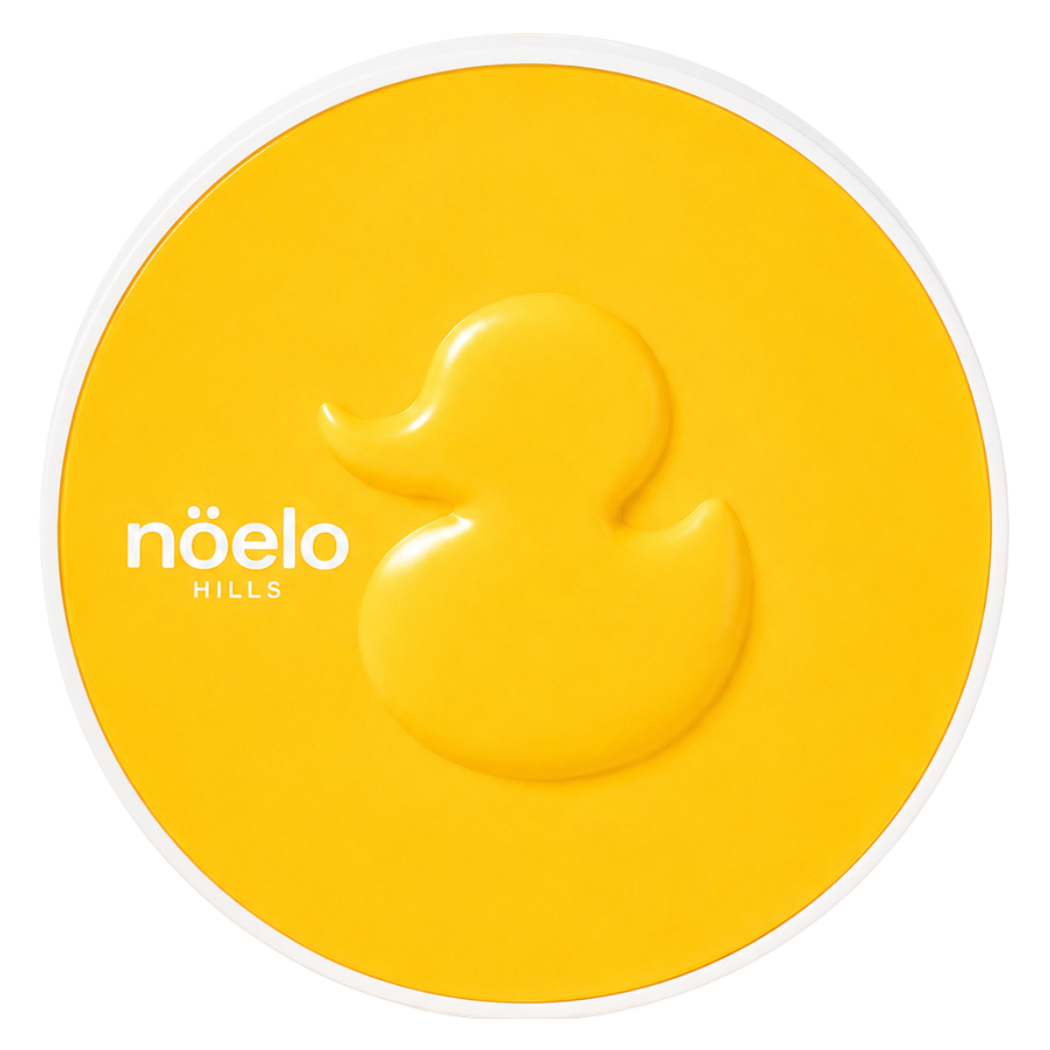 Noelo Hills Skin Barrier Sun Cushion SPF 50 Noelo Hills Skin Barrier Sun Cushion SPF50+ PA++++ – kompaktowy cushion ochronny z charakterystycznym żółtym wzorem kaczuszki na wieczku.