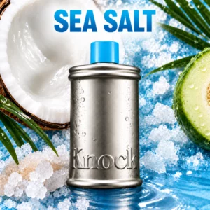 Knock Melt In Body Toner Sea Salt - mleczny tonik do ciała w srebrnym opakowaniu z niebieskim korkiem, na tle kokosa, melona, kryształków soli morskiej i wody.