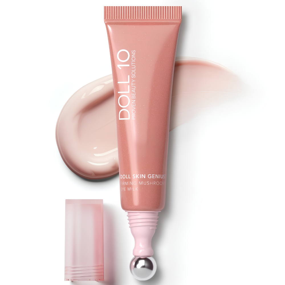 Doll 10 Mushroom Eye Milk Doll 10 Mushroom Eye Milk - ujędrniające mleczko pod oczy w różowej tubce z metalowym aplikatorem kulkowym, na tle kremowej konsystencji kosmetyku.