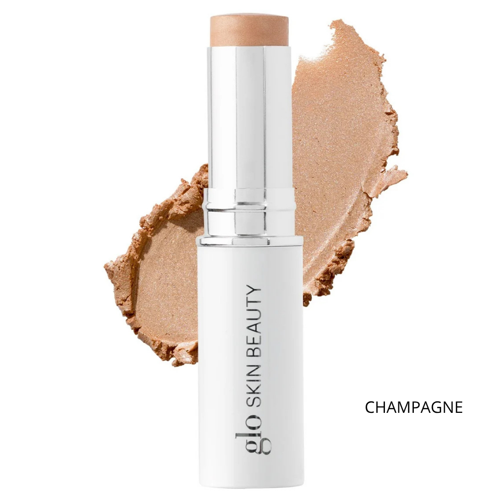 Glo Skin Beauty Skin Glow Stick Highlighter (6) Glo Skin Beauty Skin Glow Stick Highlighter Champagne - kremowy rozświetlacz w sztyfcie w szampańsko-złotym odcieniu, biało-srebrne opakowanie z logo marki oraz próbka świetlistej konsystencji na białym tle, efekt naturalnego glow.