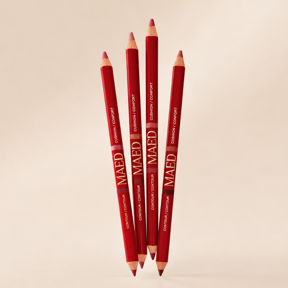 Maed Duet Satin + Matte Long Wear Lip Liner MAED Duet Satin + Matte Long Wear Lip Liner - cztery odcienie dwustronnych konturówek do ust w eleganckich czerwonych opakowaniach ze złotym logo MAED. Różowe, brązowe i mauve odcienie nude, dwie końcówki do konturowania i wypełniania ust oraz satynowo-matowe wykończenie. Produkty przedstawione na beżowym tle.