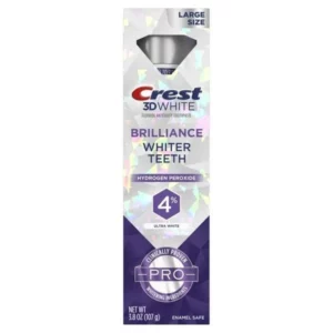 Na obrazku znajduje się opakowanie pasty do zębów Crest 3D White Brilliance Whiter Teeth z nadtlenkiem wodoru. Na opakowaniu znajduje się informacja o zawartości 4% nadtlenku wodoru oraz oznaczenie "Ultra White". Pasta jest przeznaczona do wybielania zębów i jest bezpieczna dla szkliwa. Opakowanie jest opisane jako "Large Size" i zawiera 107 g produktu.