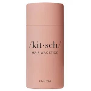 Różowy sztyft Kitsch Hair Wax Stick o pojemności 2.7 oz (75 g) na białym tle. Produkt ma minimalistyczny design z napisem „/kit•sch/ HAIR WAX STICK