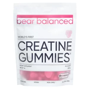 Na zdjęciu znajduje się opakowanie suplementu w żelkach Bear Balanced o nazwie "Creatine Gummies", w dużym białym woreczku z przezroczystą dolną częścią, przez którą widać różowe żelki.