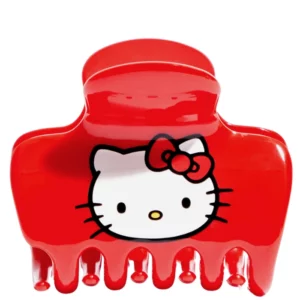 Hair 12 Na zdjęciu znajduje się czerwony klips do włosów z wizerunkiem Hello Kitty, wykonany z recyklingowanego plastiku.