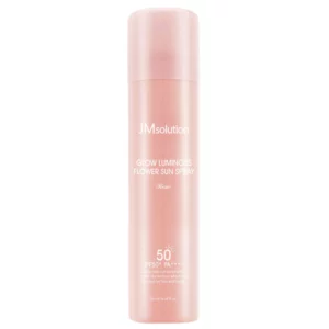 Różowa butelka w sprayu z napisem „JMsolution Glow Luminous Flower Sun Spray Rose” SPF 50+ PA++++. Kosmetyk w opakowaniu o połyskującym wykończeniu.