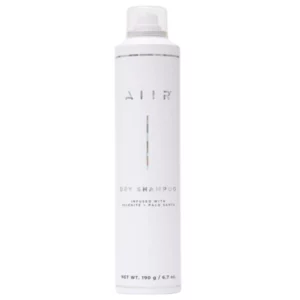 Produkt AIIR Dry Shampoo w formie białej butelki z minimalistycznym designem i holograficznym logo, widok na neutralnym tle.