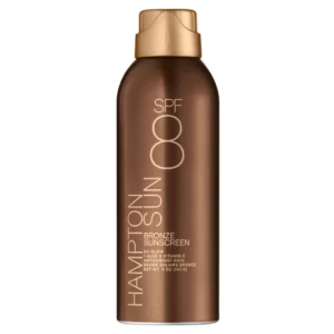 Brązowa butelka sprayu Hampton Sun SPF 8 Bronze Sunscreen z złotą nakrętką i złotym nadrukiem – bronzujący spray z aloesem i witaminą E.