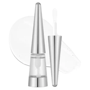 Błyszczyk VT Cosmetics Reedle Shot Lip Plumper Beginner z metaliczną nakrętką i białym aplikatorem na tle rozprowadzonej, przezroczystej formuły.