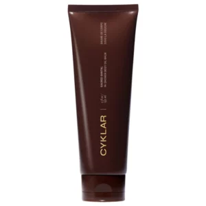 Brązowa tuba balsamu pod prysznic Cyklar Sacred Santal In-Shower Body Oil Balm na białym tle.
