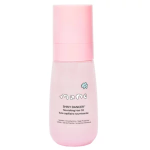 Produkt Mane Shiny Dancer Nourishing Hair Oil w przezroczystej butelce z różową nakrętką, widoczna etykieta i opis funkcji: nawilża, wygładza puszenie i chroni przed ciepłem.