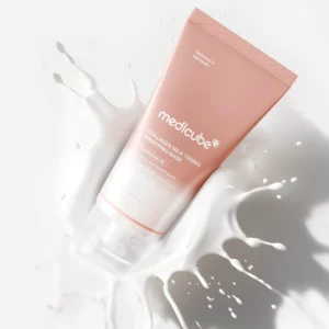 Sale 2 Tubka maski Medicube Collagen Milk Toning Wrapping Mask położona na tle rozlanej, mlecznej emulsji podkreślającej kremową konsystencję produktu.