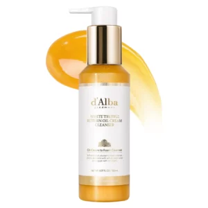 Packshot d’Alba White Truffle Return Oil Cream Cleanser z widoczną smugą złotego olejku w tle.