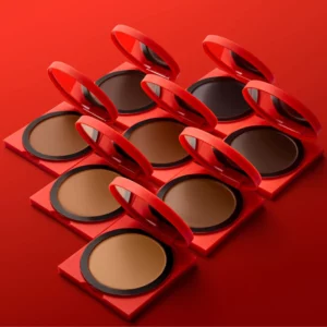 makeup 17 Zestaw bronzerów Hung Vanngo Tansculpt w różnych odcieniach w czerwonych opakowaniach na intensywnym tle.