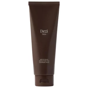 Dezi Skin Skin So Balm Makeup Melting Cleansing Balm w minimalistycznej brązowej tubie na jasnym tle.
