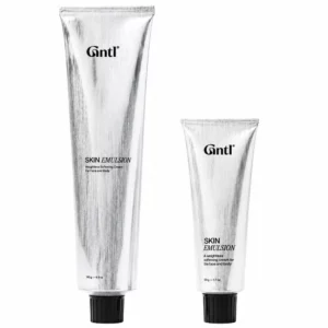 body 7 Dwie srebrne tuby kremu Gntl Skin Emulsion z czarnymi zakrętkami na białym tle, w rozmiarach 140 g i 50 g.