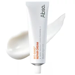 Abso Bio-Band Repair Cream - krem regenerujący do twarzy w białej tubce, przedstawiony na jasnym tle z widoczną kremową konsystencją produktu.